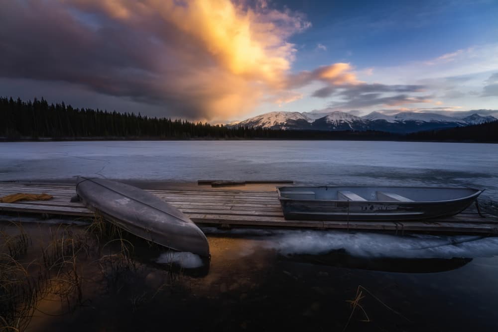 Frozen Lake Sunset Boats by Yongnan Li (李永男) — canvas wall art