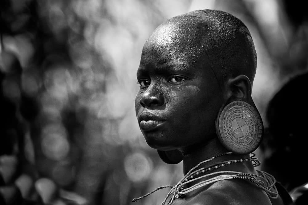 African Youth Earplugs by Trevor Cole — canvas wall art
