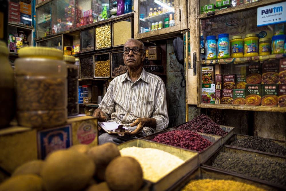 Traditional Spice Shop Owner by Marco Tagliarino — canvas wall art