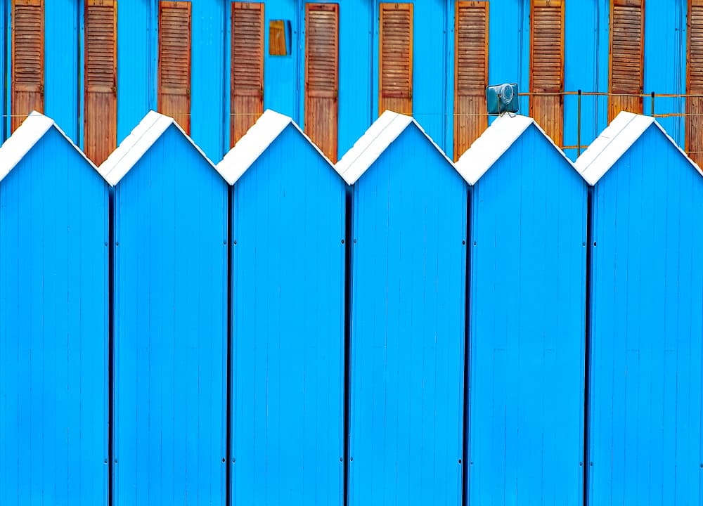 Vibrant Blue Beach Huts by Wayne Pearson — canvas wall art