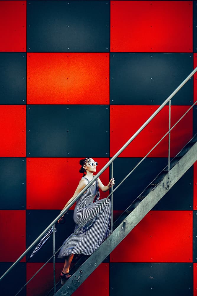 Stylish Woman on Red Stairs by Ruslan Bolgov — canvas wall art