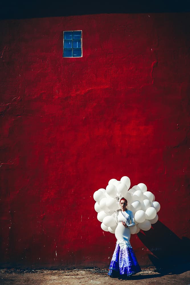 Red Wall Woman Balloons by Ruslan Bolgov — canvas wall art