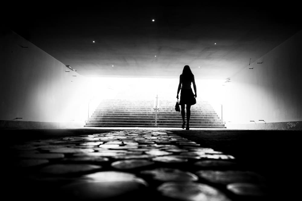 Woman Walking Towards Light by Marius Cinteza — canvas wall art