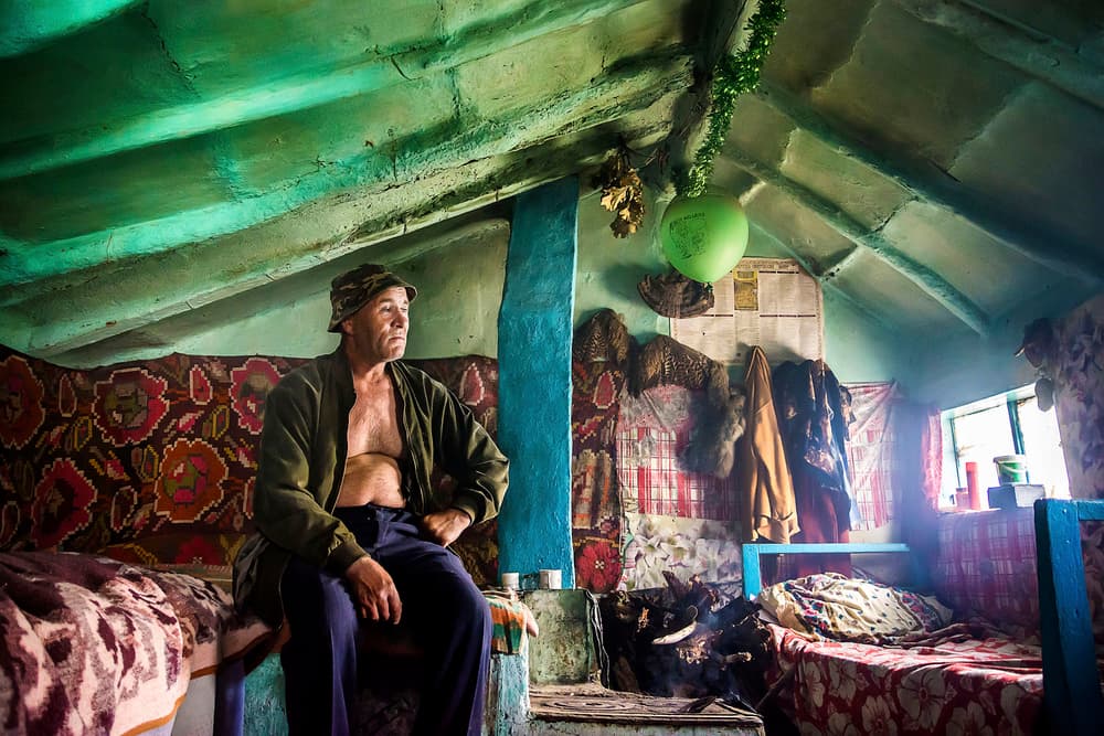 Man In Rustic Home by Elena Raceala — canvas wall art