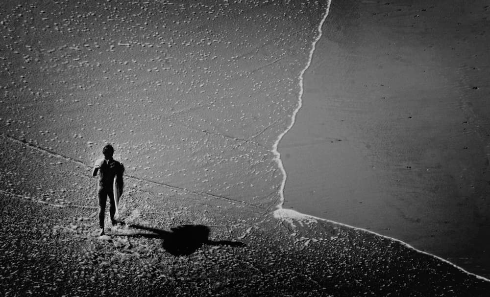 Lone Surfer Shoreline by Elena Arjona — canvas wall art