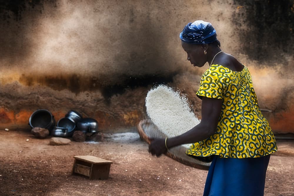 African Woman Sifting Rice by Sergio Pandolfini — canvas wall art