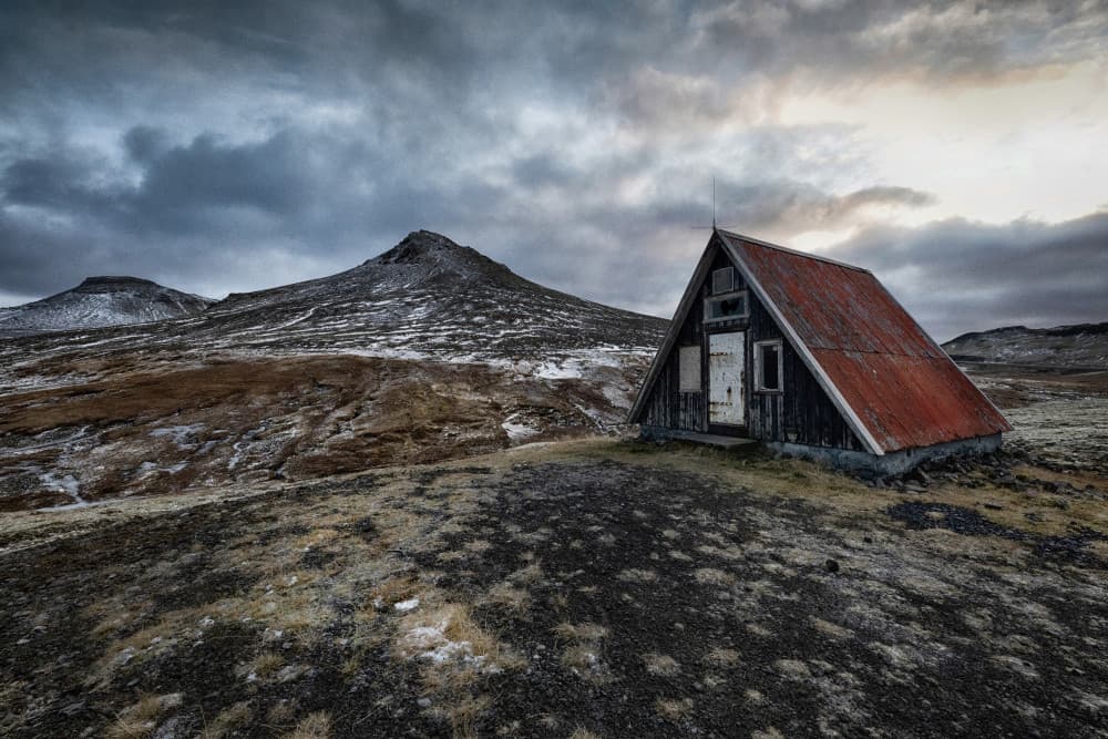 Rustic Cabin Amidst Mountains by Þorsteinn H. Ingibergsson — canvas wall art