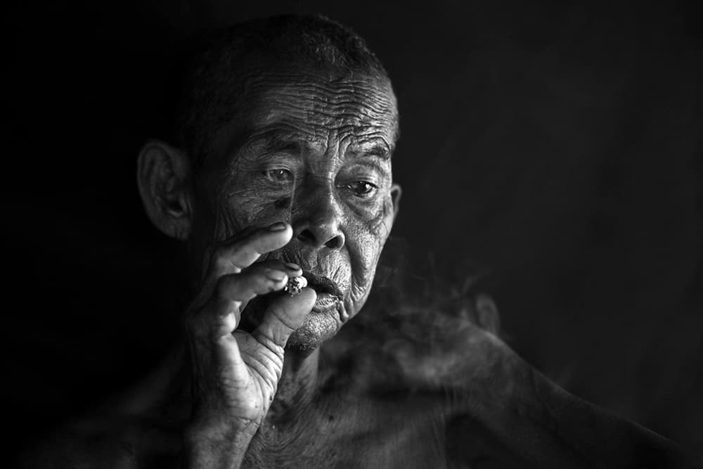 Contemplative Old Man Smoking by Ajie Alrasyid — canvas wall art
