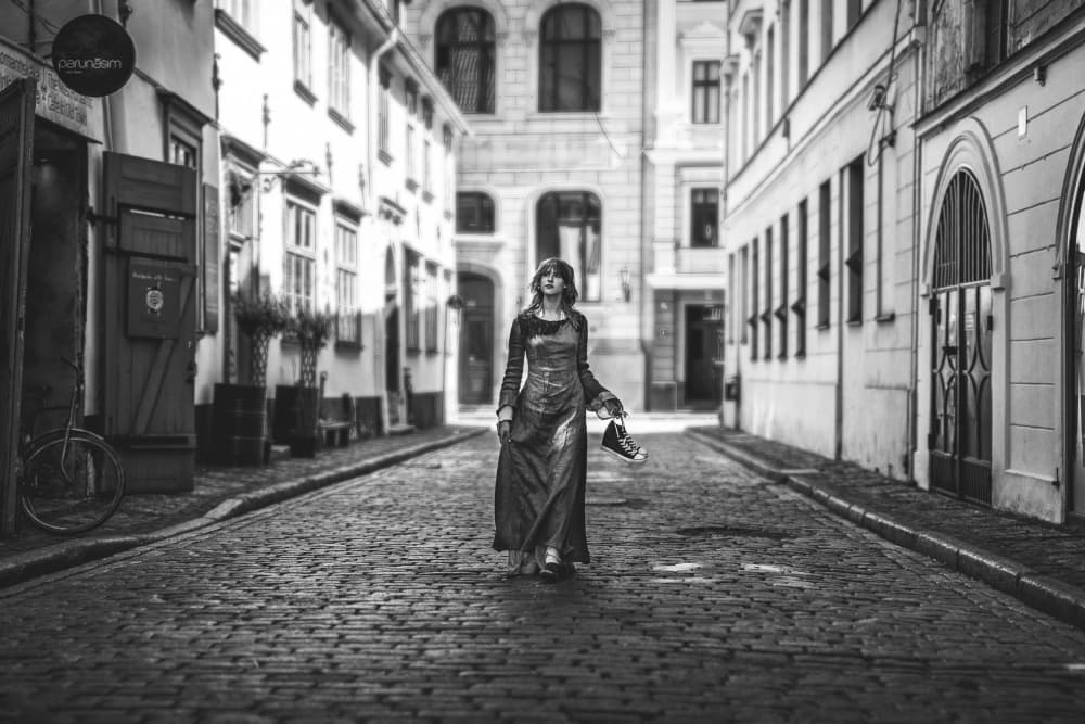 Woman On Cobblestone Street by Normunds Kaprano — canvas wall art