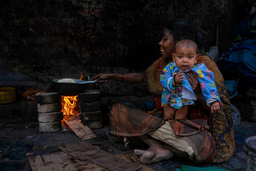 Mother Cooking Hearth Warmth by Kuntal Biswas — canvas wall art