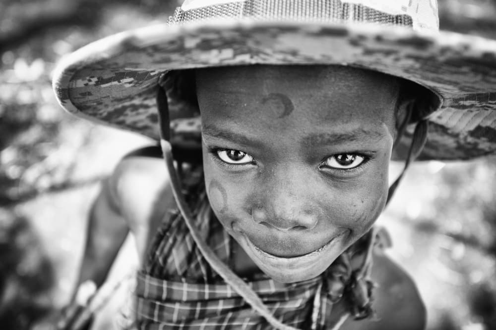Smiling Boy In Hat by Goran Jovic — canvas wall art