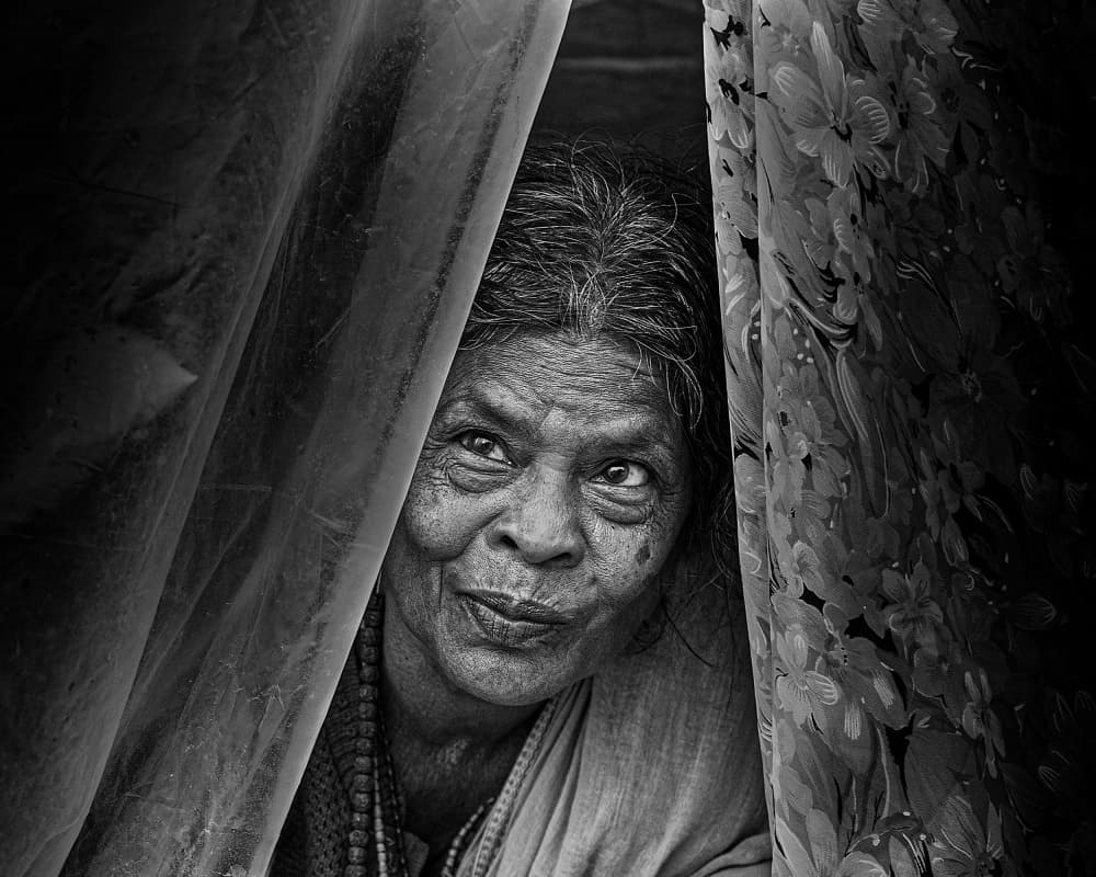 Woman Peeking Through Curtains by Som Prasad — canvas wall art