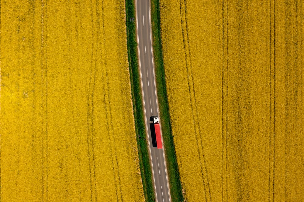 Red Truck Yellow Fields by Jure Kravanja — canvas wall art