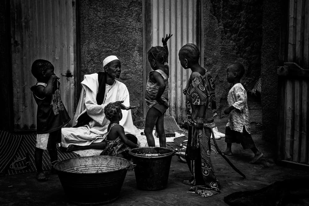 African Elder and Kids by Joxe Inazio Kuesta Garmendia — canvas wall art