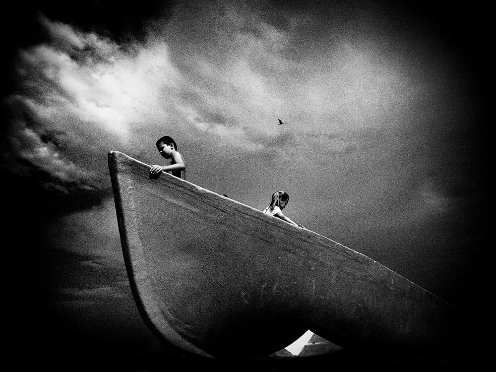 Children Under Dramatic Sky by Mirela Momanu — canvas wall art