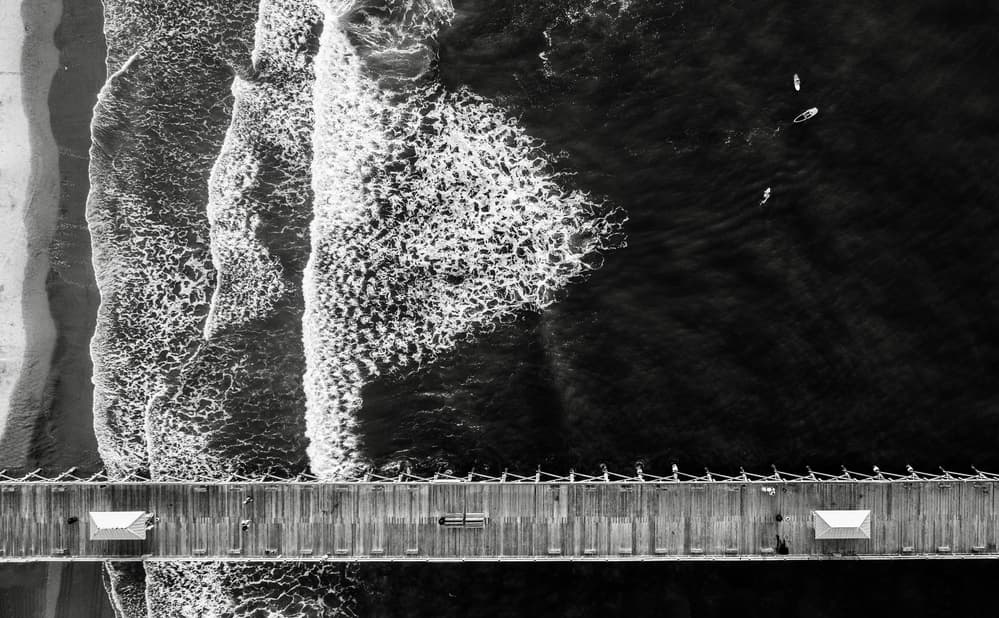 Ocean Pier and Surfers by Rob Darby — canvas wall art