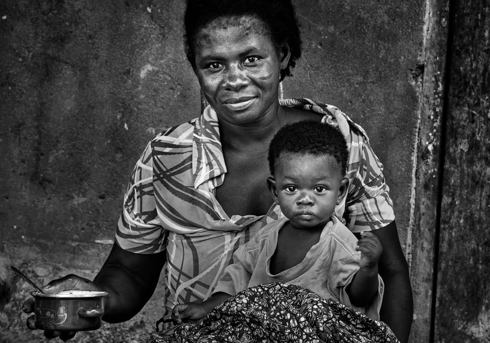African Mother Child Smile by Joxe Inazio Kuesta Garmendia — canvas wall art