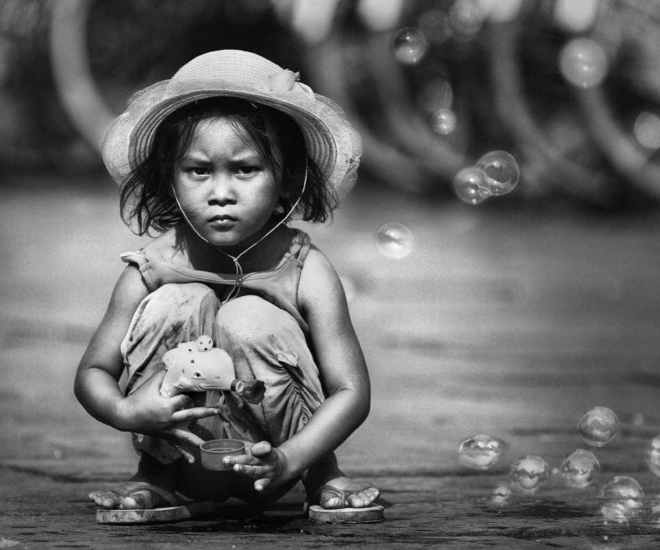 Pensive Child With Bubbles by Sebastian Kisworo — canvas wall art