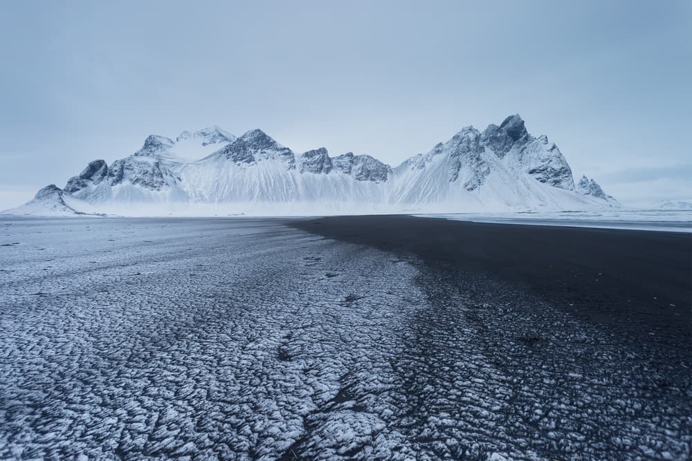 Snowy Peaks Black Beach by Paolo Stoppani — canvas wall art