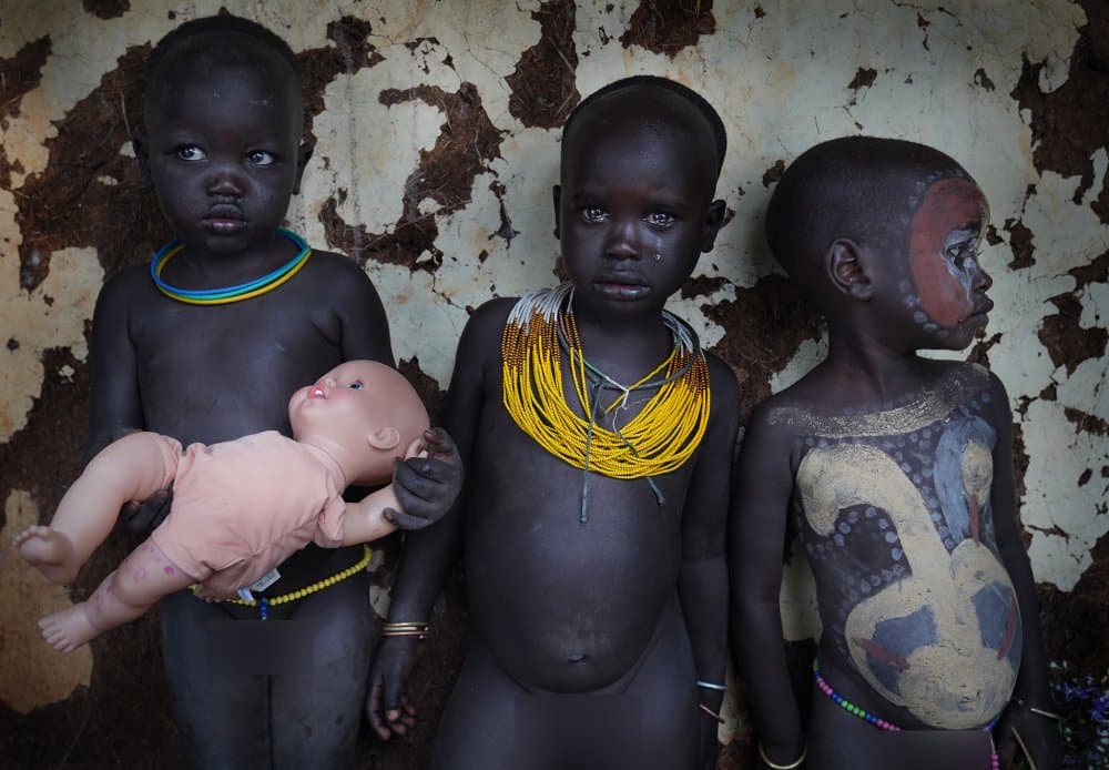 African Children and Doll by Sarawut Intarob — canvas wall art