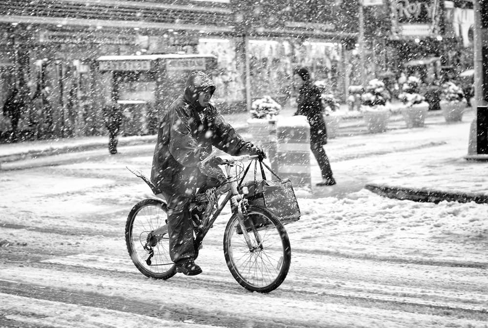 Snowy City Cyclist by Martin Froyda — canvas wall art