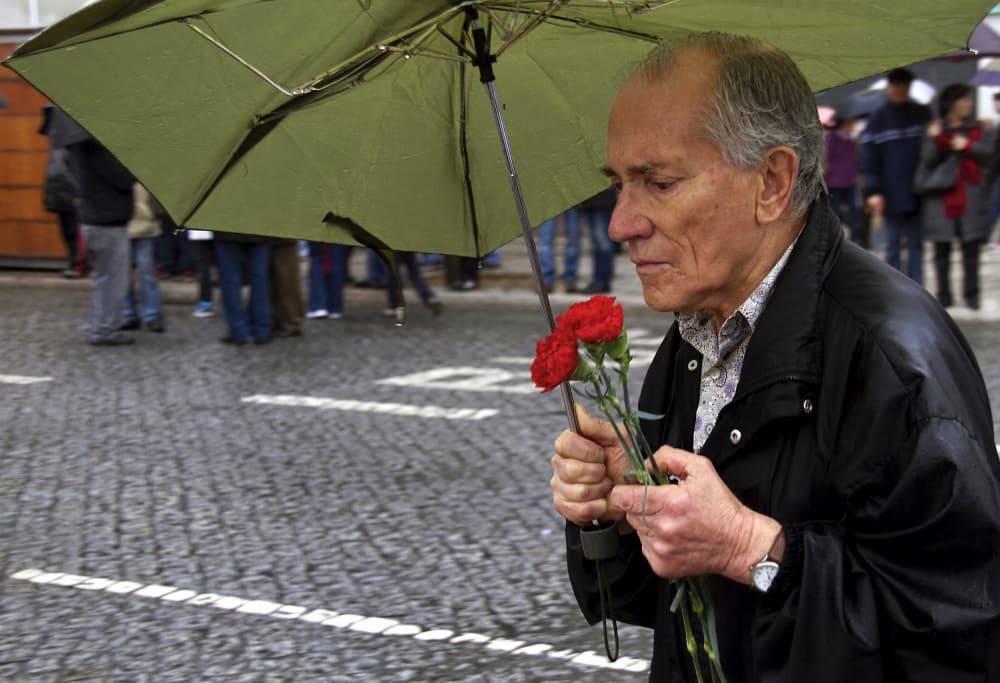 Man Holding Red Carnations by Fernando Alves — canvas wall art
