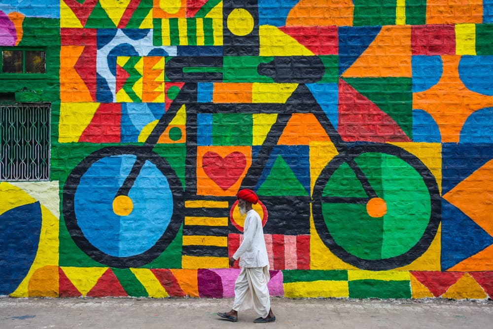 Man By Vibrant Mural by Saurabh Sirohiya — canvas wall art