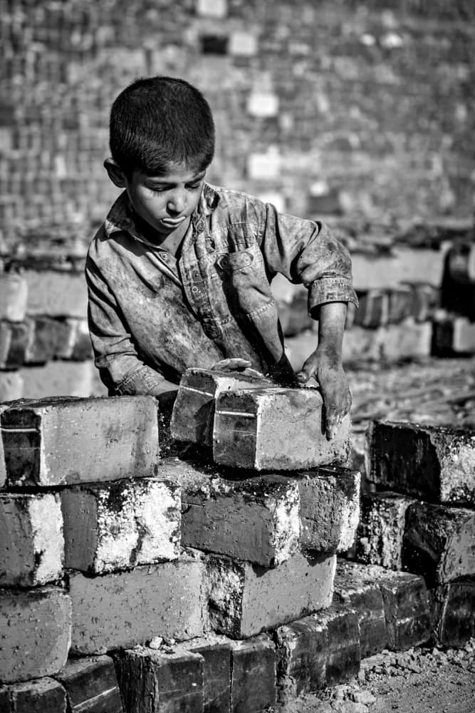 Young Boy Stacking Bricks by Mohammadreza Momeni — canvas wall art