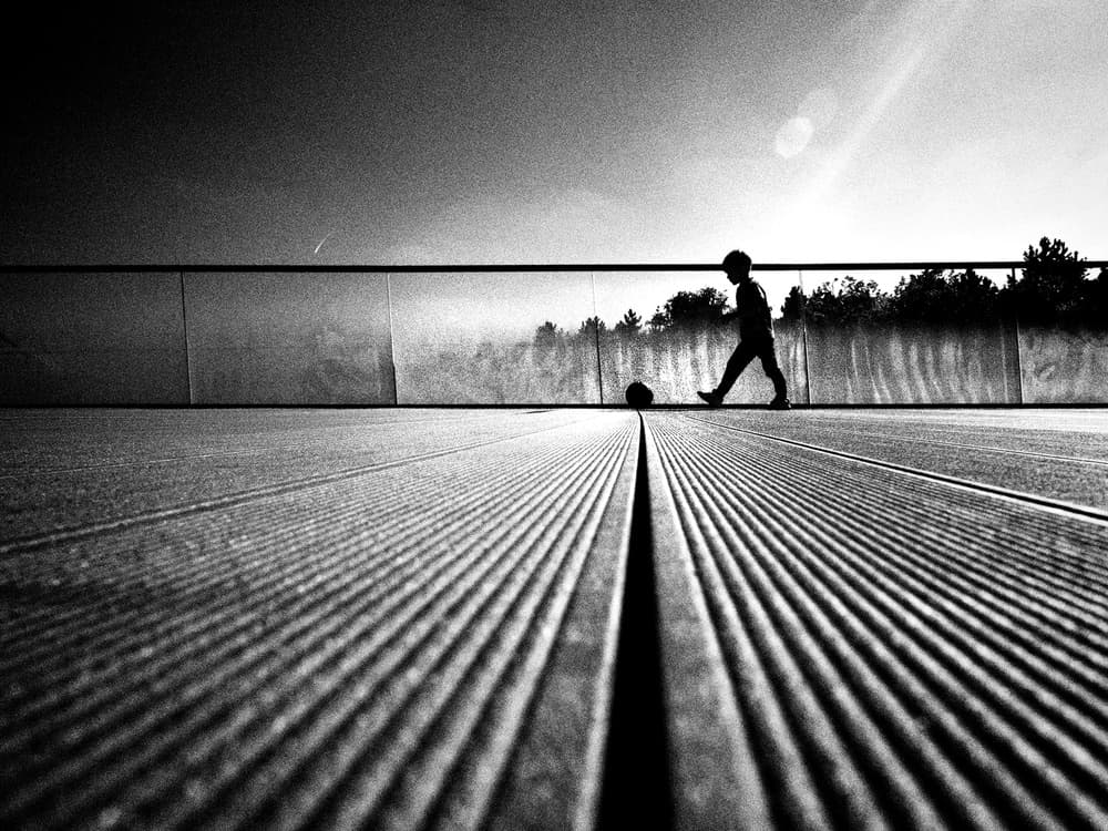 Boy Playing Football by Mirela Momanu — canvas wall art