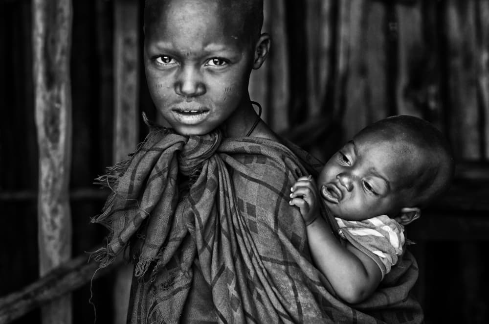 African Child with Infant by Goran Jovic — canvas wall art