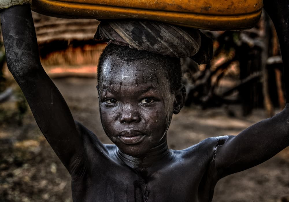 African Child Carrying Water by Joxe Inazio Kuesta Garmendia — canvas wall art