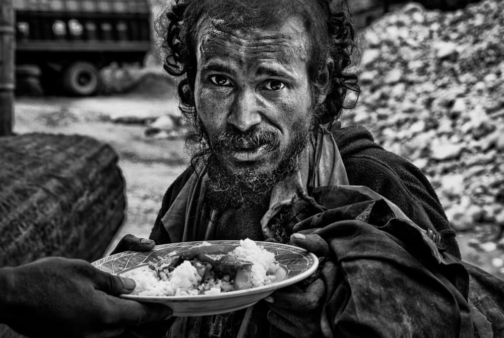 Man Receiving Food by Joxe Inazio Kuesta Garmendia — canvas wall art