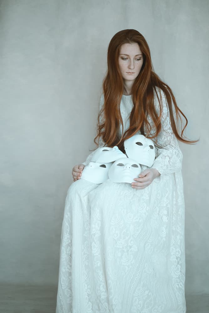 Woman Holding Masks by Raluca Arhire — canvas wall art