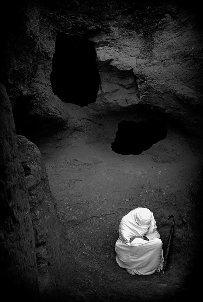 Praying Monk in Cave by Joxe Inazio Kuesta Garmendia — canvas wall art
