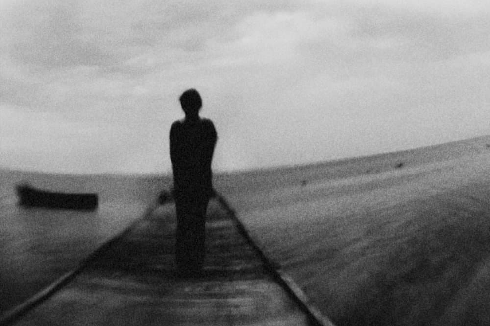 Lonely Figure on Pier by Bogdan Bouşcă — canvas wall art