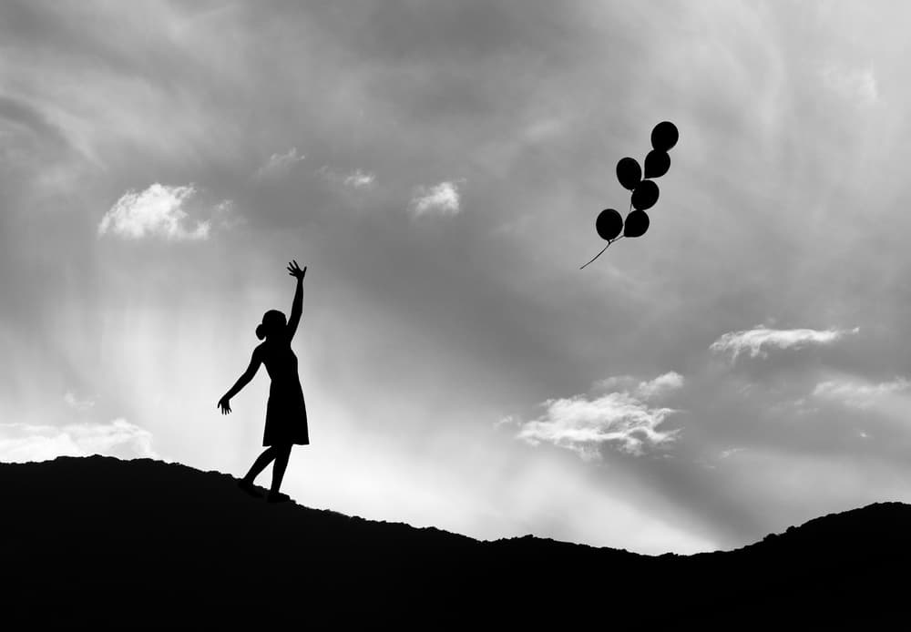 Silhouette and Floating Balloons by Jacqueline Hammer — canvas wall art