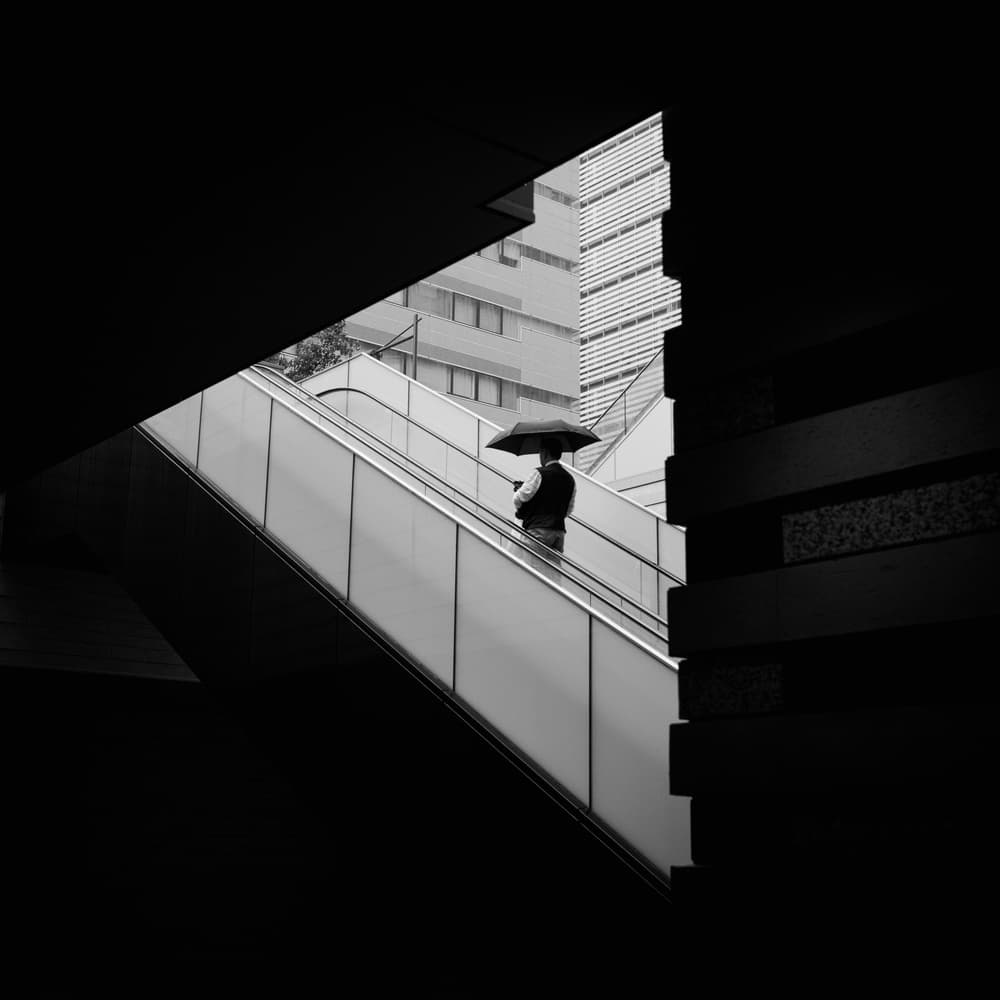 Man on City Escalator by Yasuhiro Takachi — canvas wall art