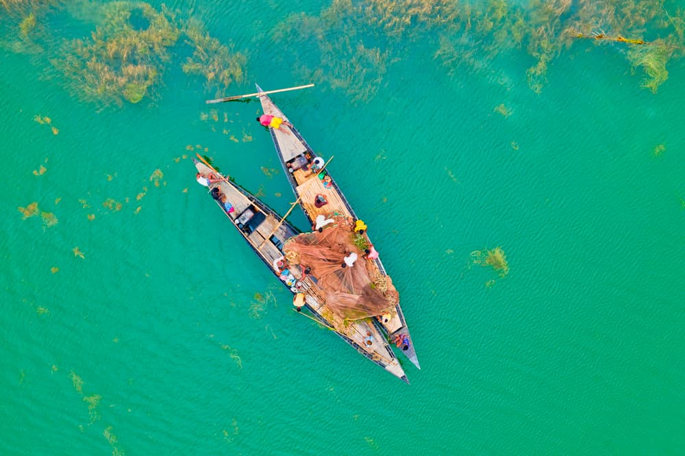 Fishermen On Turquoise Water by Azim Khan Ronnie — canvas wall art
