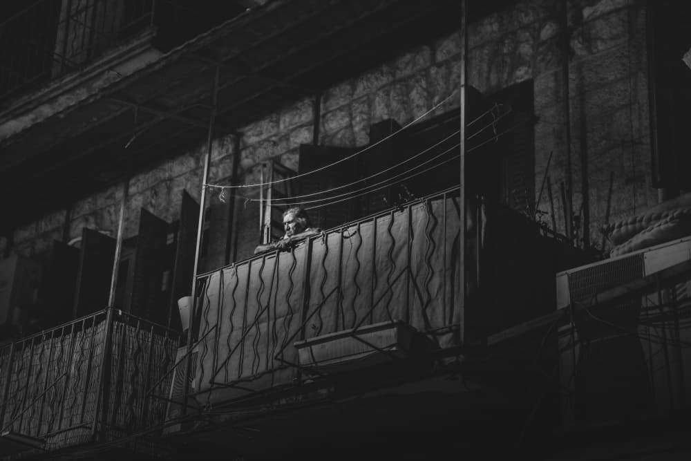 Pensive Man Balcony by Sharon Levy — canvas wall art
