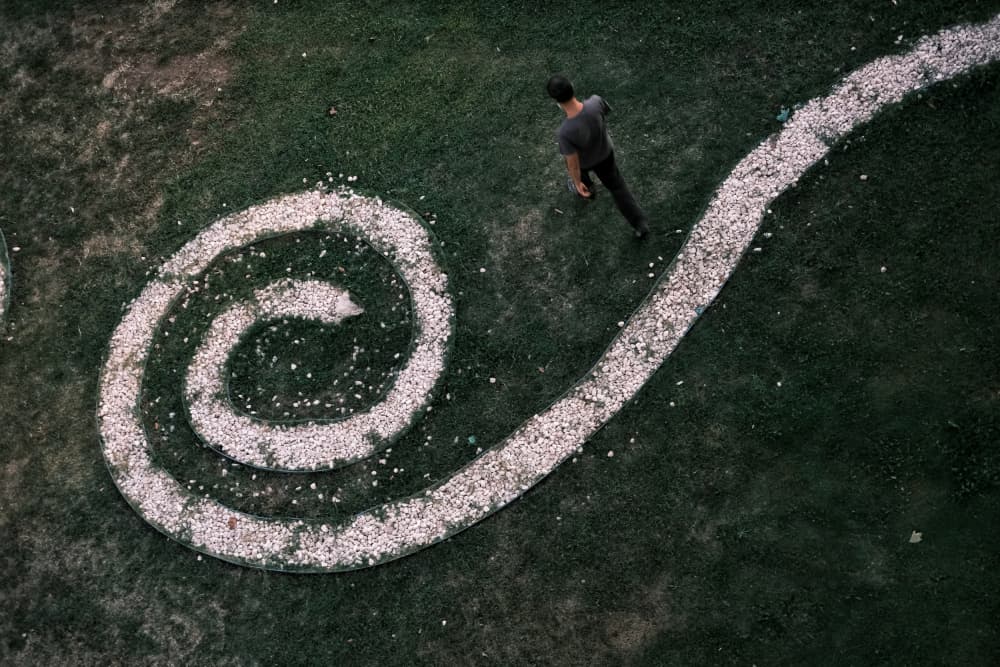 Man Walking Spiral Path by Ali Ayer — canvas wall art