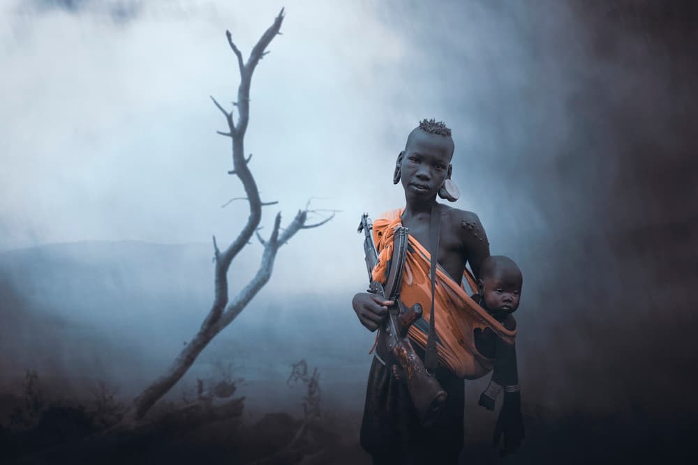 African Boy Carrying Rifle by Svetlin Yosifov — canvas wall art