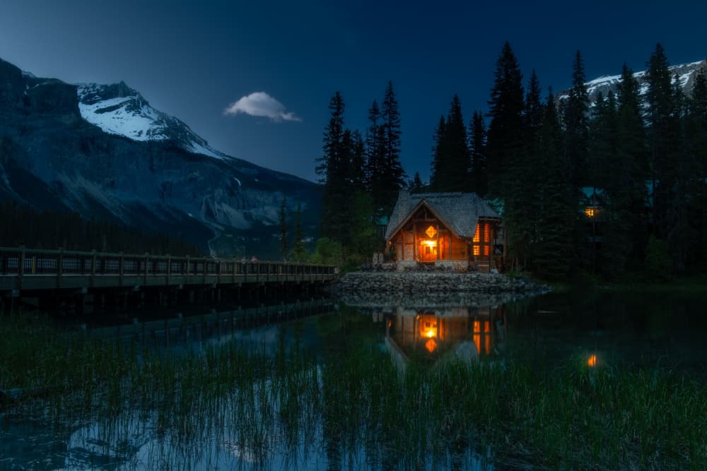 Glowing Cabin Lake Night by Ambar Saha — canvas wall art