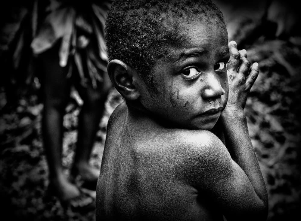 Child's Somber Gaze by Joxe Inazio Kuesta Garmendia — canvas wall art