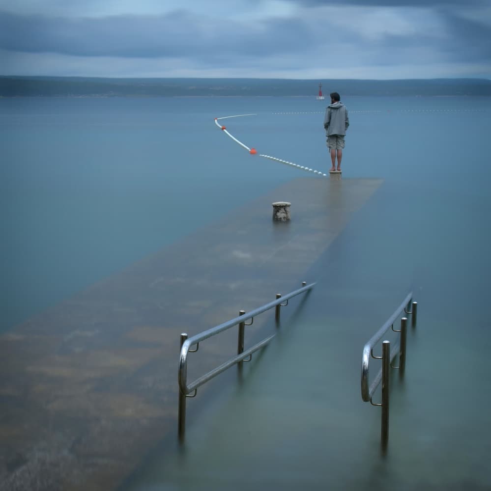 Man on Submerged Pier by Primož Kožuh — canvas wall art