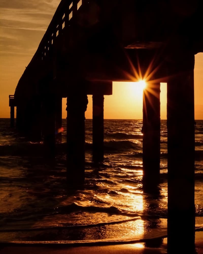 Sunburst Under Pier by Del Mundo Imagery — canvas wall art