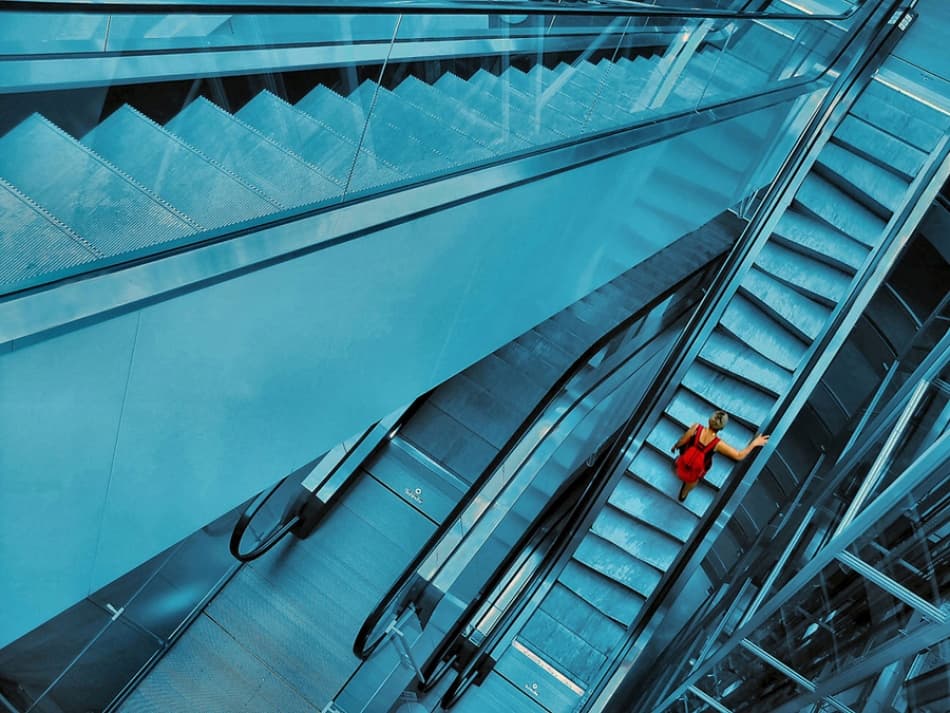 Woman Ascending Escalator by Jure Kravanja — canvas wall art