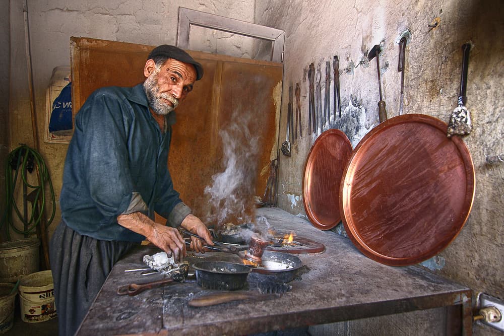 Traditional Coppersmith at Work by Emine Basa — canvas wall art