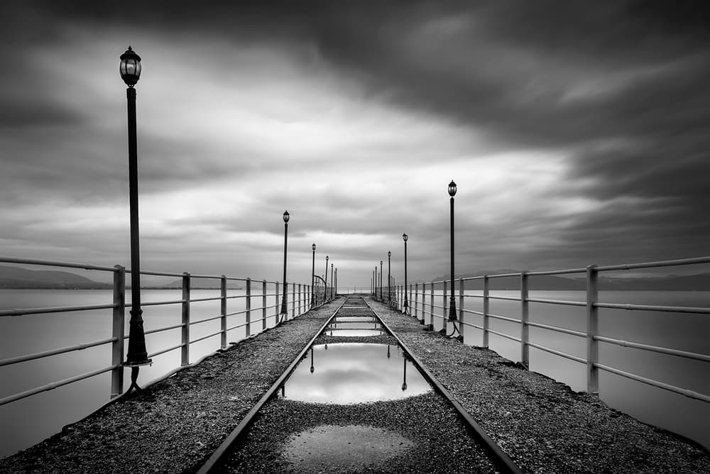 Moody Pier Reflections by George Digalakis — canvas wall art