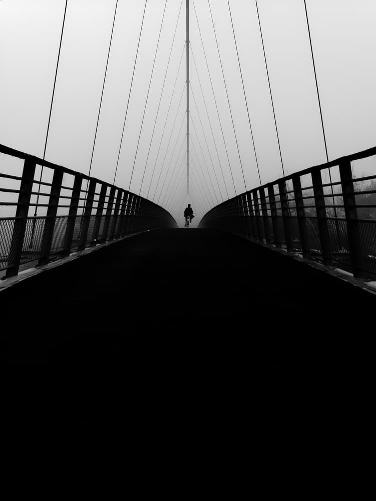 Misty Bridge Cyclist by Marius Surleac — canvas wall art