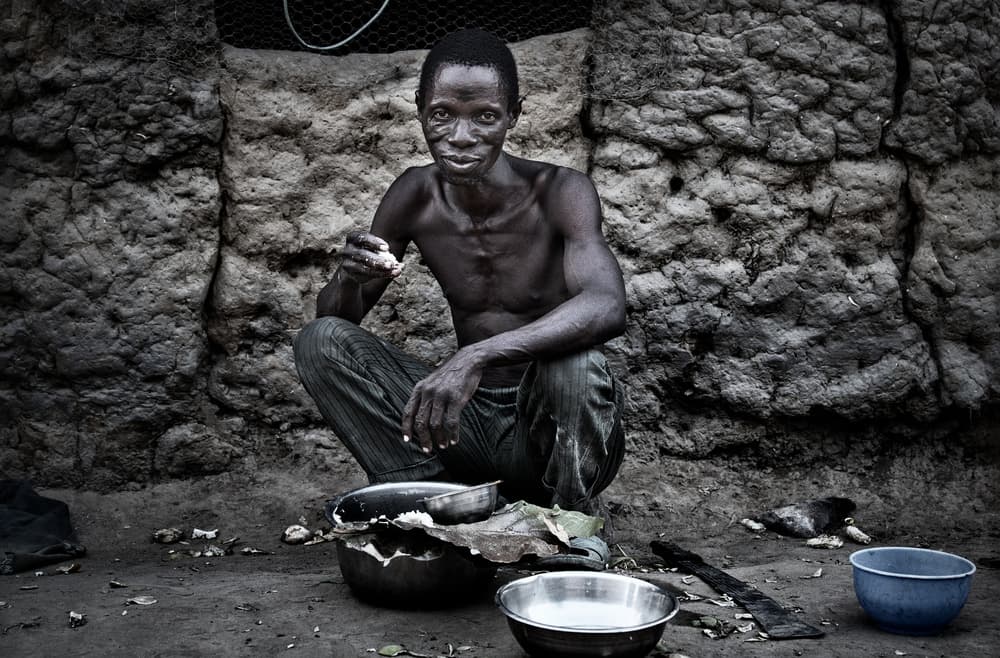 African Man Eating by Joxe Inazio Kuesta Garmendia — canvas wall art